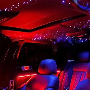 Car interior with LED lights creating a starry effect on the ceiling.