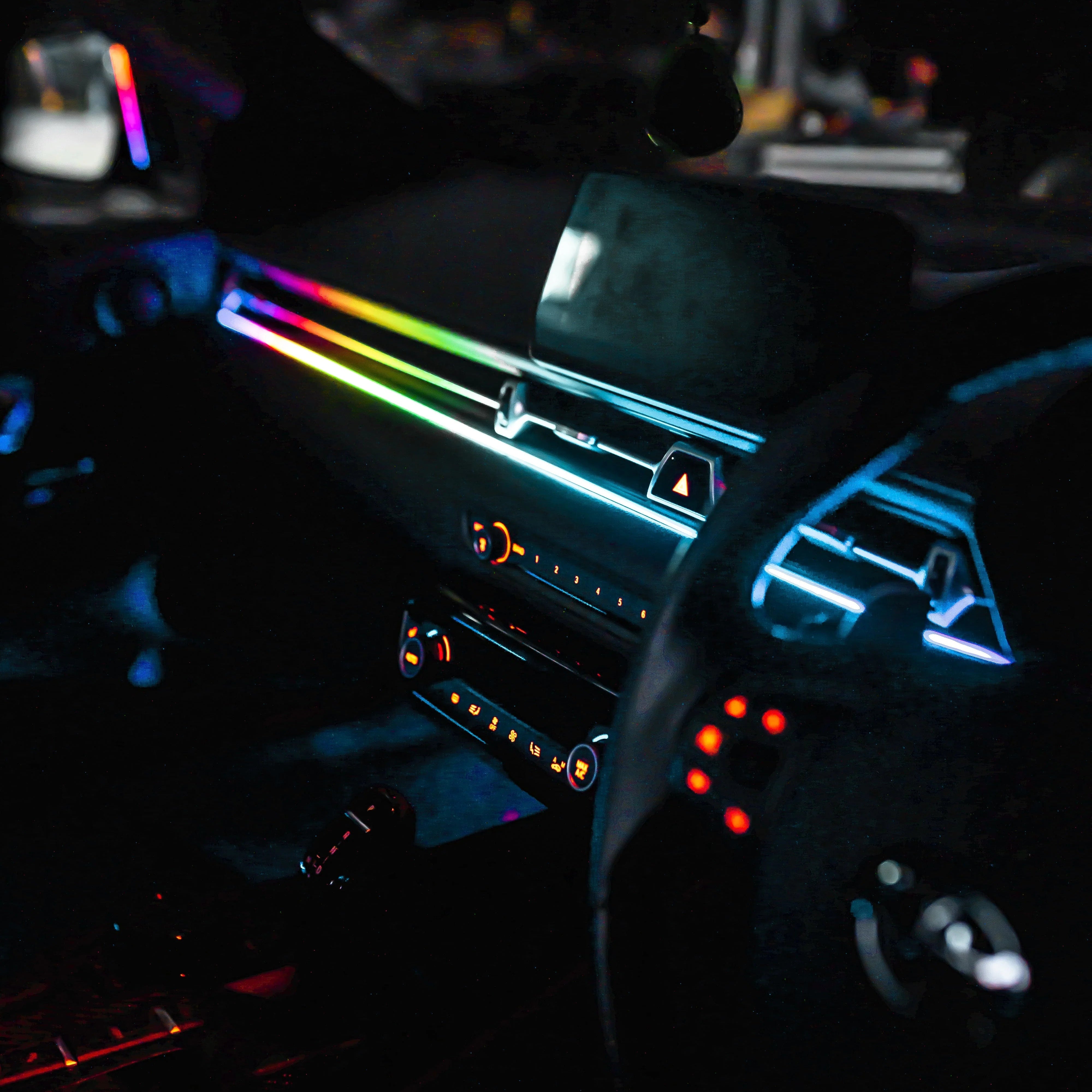 Car interior with neon lights illuminating the dashboard and steering wheel. Ambient lighting kit, universal car kit
diy installation 